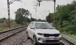 Woman Drives Car on Railway Line, Threatens Locals with Knife